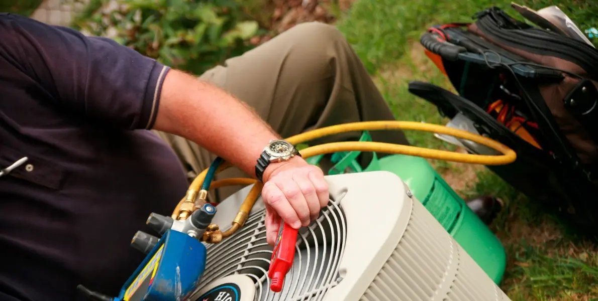Annual AC maintenance check being performed on split unit